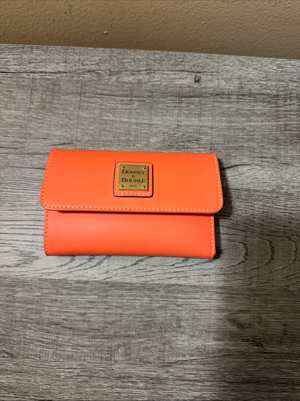 Dooney & Bourke Bright Orange Leather Flap Wallet with Brass Logo Plaque
